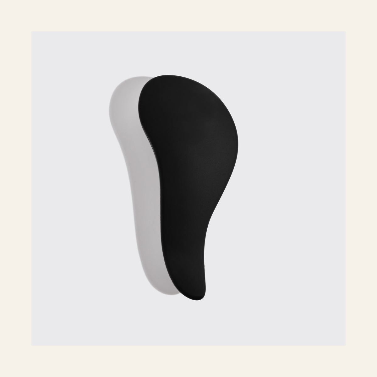 Smooth curved back of the black Kitsch detangling brush