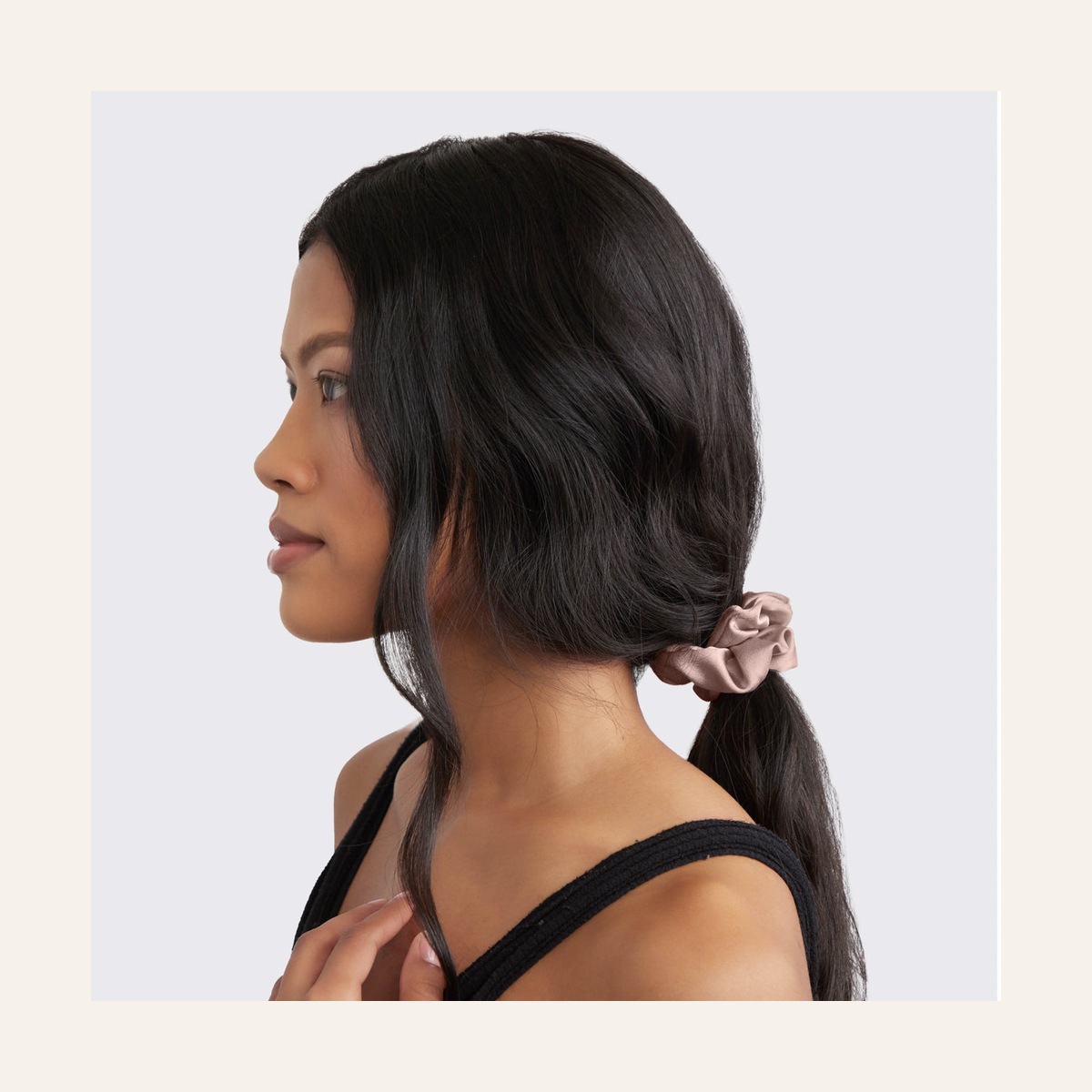 Model wearing a pink Cameo satin scrunchie in a low ponytail