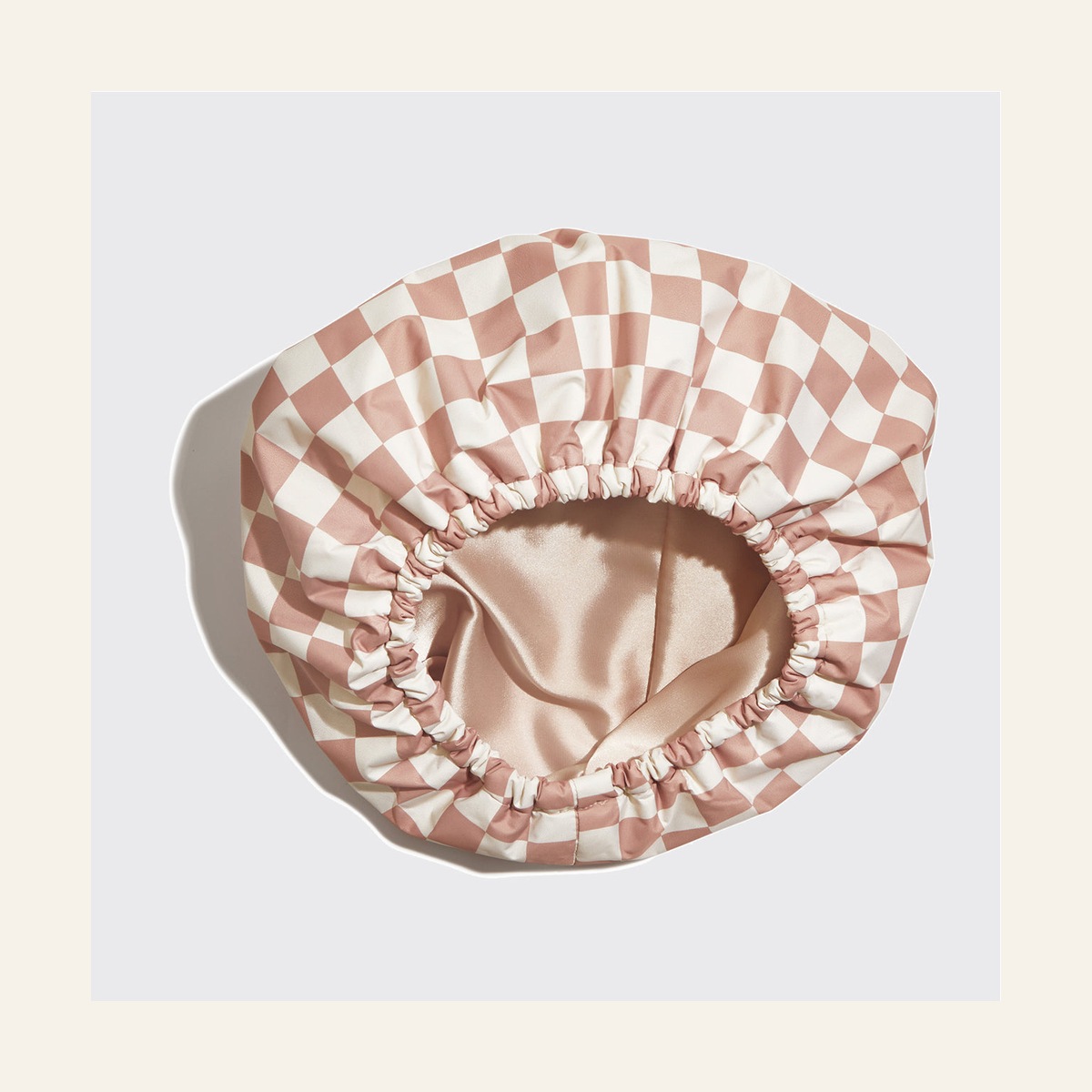 Inside view of the Terracotta Checker shower cap showing its satin lining
