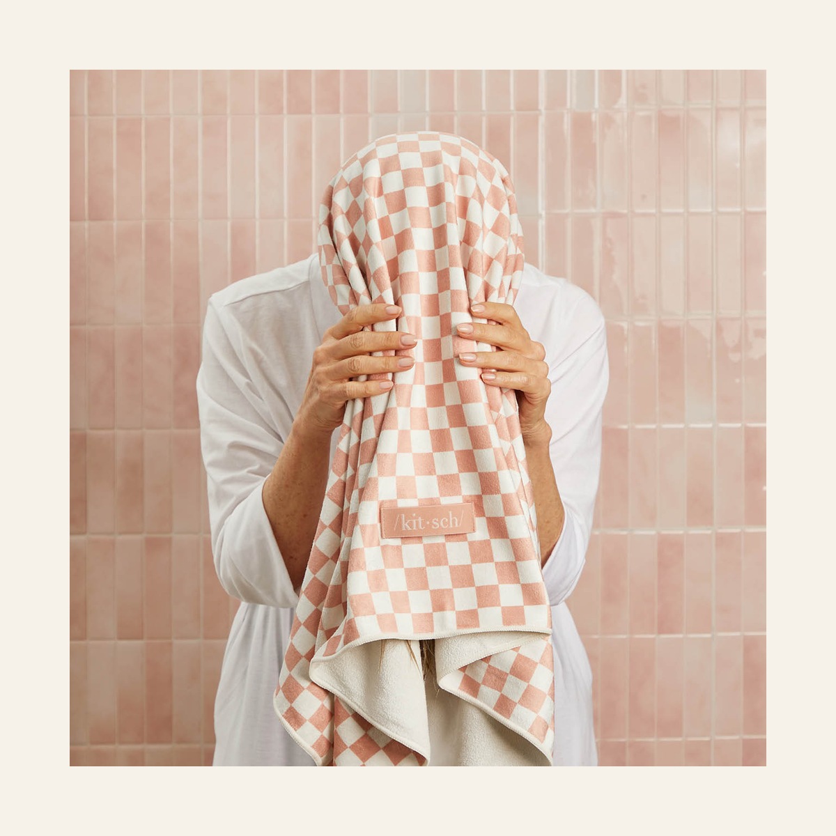 Model gathering hair into the Terracotta Checker microfiber towel before wrapping