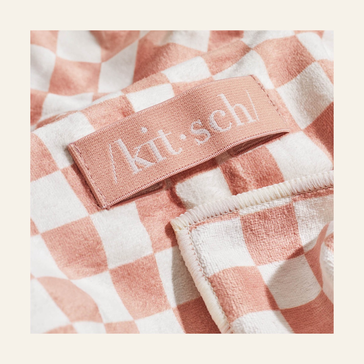 Kitsch XL Hair Towel close-up showing the terracotta and cream check pattern and fabric label