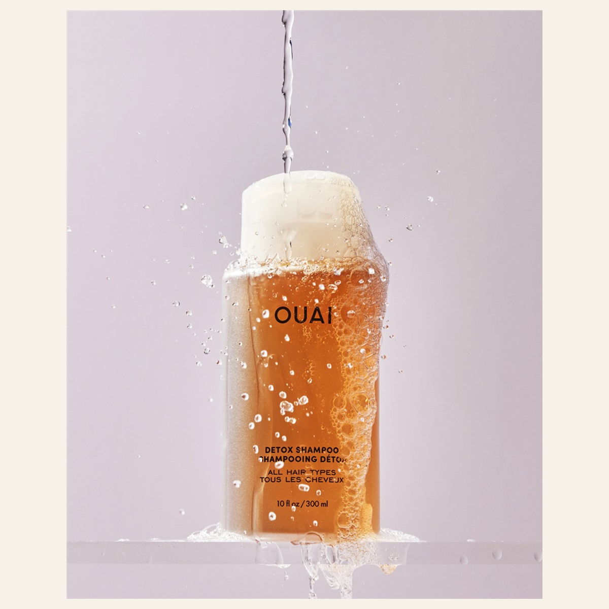OUAI Detox Shampoo 300 ml bottle with water and foam