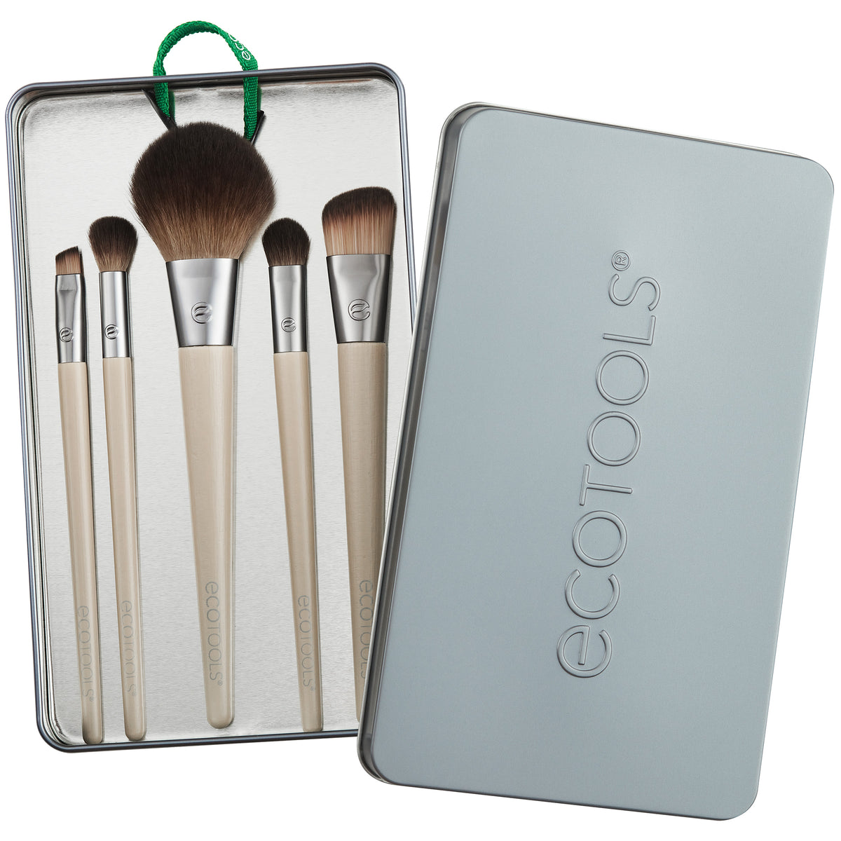 EcoTools makeup brushes inside the open reusable gray storage tin